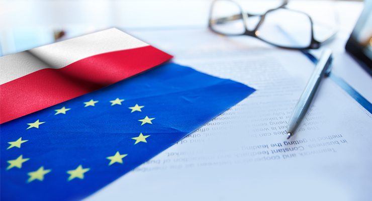 Baner przedstawiający flagi Polski oraz Unii Europejskiej na tle dokumentu z leżącym na nim długopisem oraz okularami.